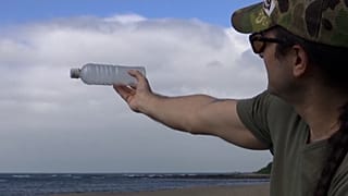 Jean Scuderi collecting plastic waste from a beach in northern Taiwan