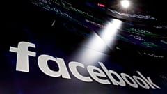 In this March 29, 2018, file photo the logo for Facebook appears on screens at the Nasdaq MarketSite in New York's Times Square