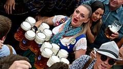 In this Saturday, Sept. 21, 2019 file photo, a waitress holds twelve glasses of beer during the opening of the 186th 'Oktoberfest' beer festival in Munich, Germany