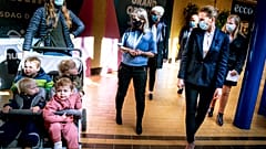 Denmark's Prime Minister Mette Frederiksen, right, meets people, during her visit to the shopping center SlotsArkaderne in Hilleroed, Denmark, Thursday 22 April 2021, 