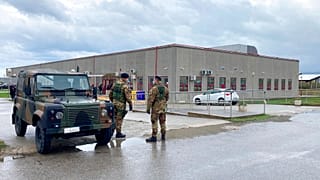 Financial police stand guart outside a modified courthouse in Calabria, Italy at the opening of a 'maxi-trial' of more than 350 alleged 'ndrangheta members in January