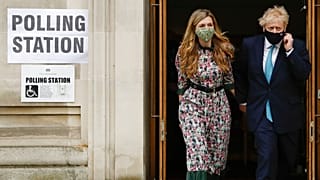 Prime Minister Boris Johnson leaves a polling station with his partner Carrie Symonds