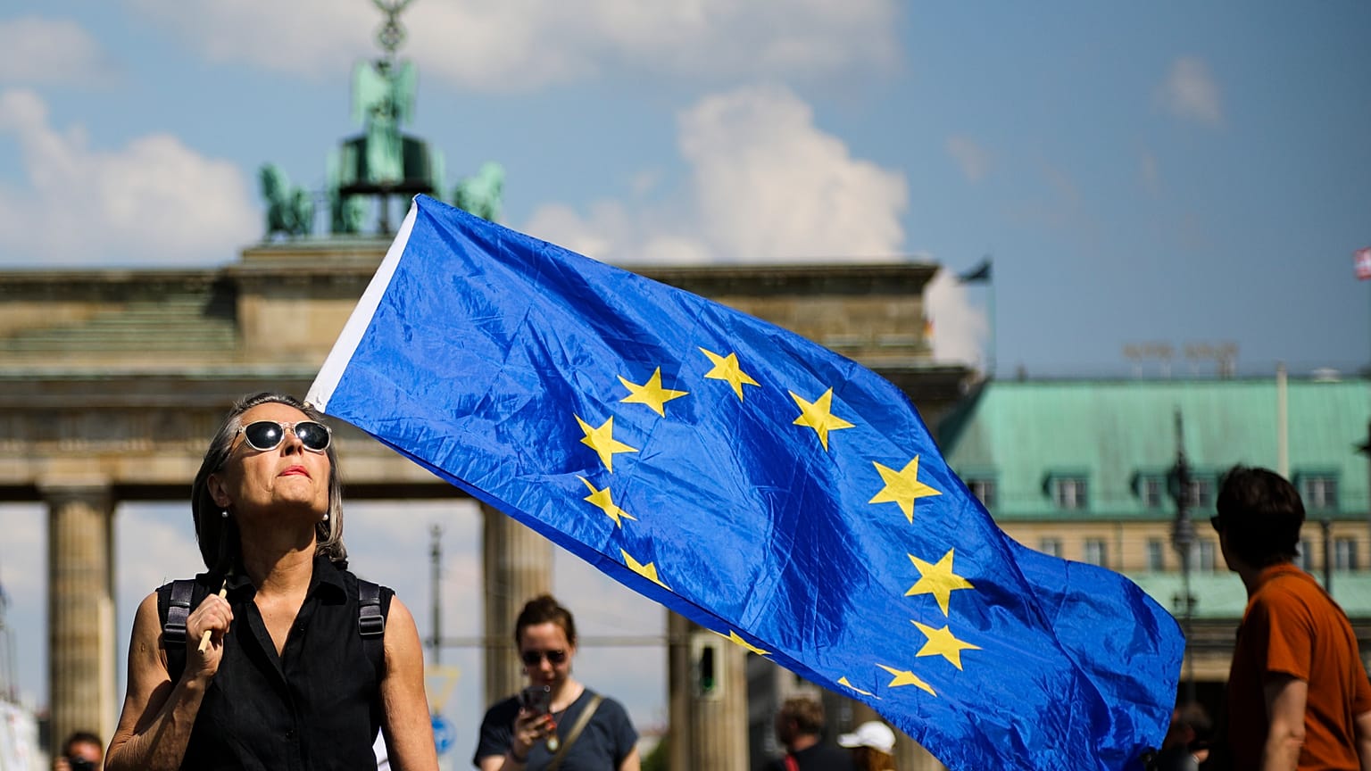 FILE: A woman holds a European flag as she attends a demonstration in Berlin, Germany, Sunday, May 19, 2019.