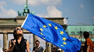 FILE: A woman holds a European flag as she attends a demonstration in Berlin, Germany, Sunday, May 19, 2019.