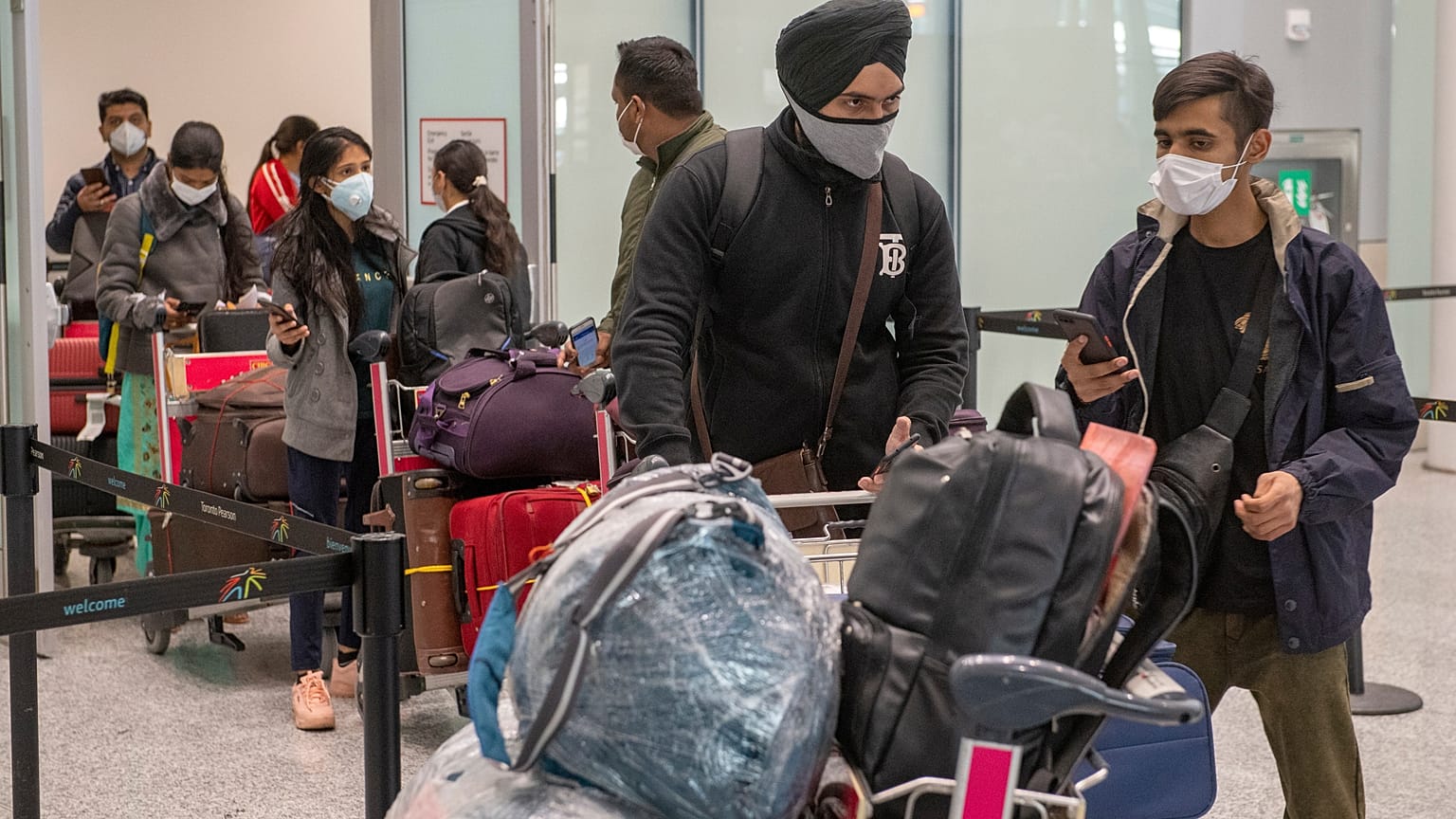 Passengers from New Delhi wait in long lines for COVID19 testing