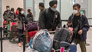 Passengers from New Delhi wait in long lines for COVID19 testing