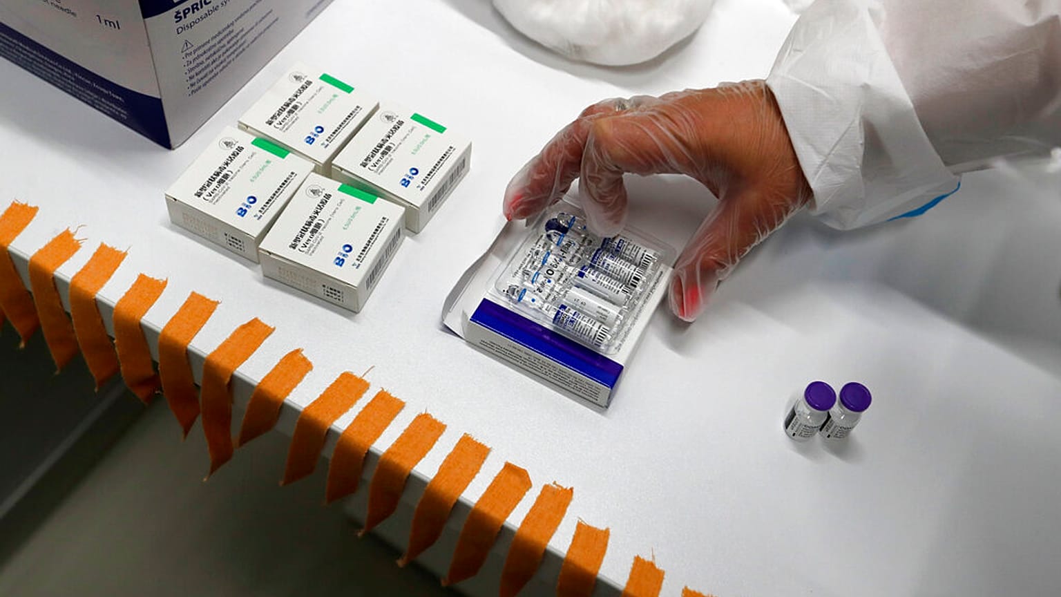 A medical worker prepares vials of the COVID-19 vaccines, Chinese Sinopharm, left, Sputnik V, center, and Pfizer at a vaccine centre, in the Usce shopping mall in Belgrade.