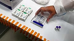 A medical worker prepares vials of the COVID-19 vaccines, Chinese Sinopharm, left, Sputnik V, center, and Pfizer at a vaccine centre, in the Usce shopping mall in Belgrade.