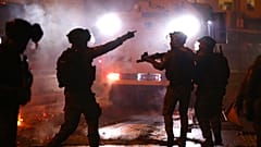 Israeli police officers fire stun grenades towards Palestinian demonstrators during clashes at Damascus Gate just outside Jerusalem's Old City