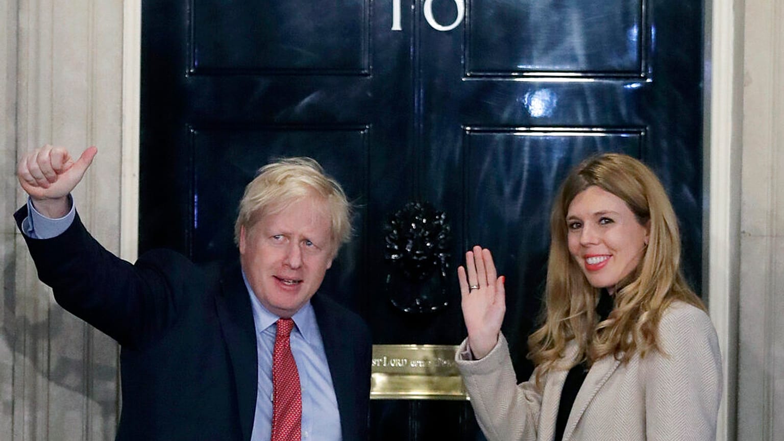 Boris Johnson and his partner Carrie Symonds wave from the steps of number 10 Downing Street (Dec 2019)