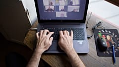 A man works from home as multinationals seek to make remote work permanent.