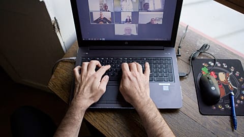 A man works from home as multinationals seek to make remote work permanent.
