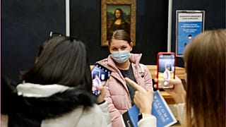 Students stood by Da Vinci's great masterpiece, the Mona Lisa
