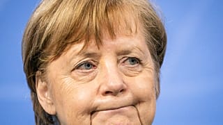 German Chancellor Angela Merkel attends a press conference in the Chancellor's Office following consultations between the federal and state governments in Berlin