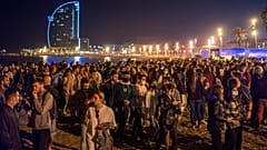 People crowded on the beach in Barcelona, Spain, Sunday, May 9, 2021. Barcelona residents were euphoric as the clock stroke midnight, ending a six-month state of emergency.
