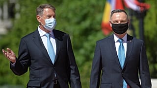 Polish President Andrzej Duda, right, reviews the honor guard with Romanian President Klaus Iohannis during the welcoming ceremony at the Cotroceni presidential palace.