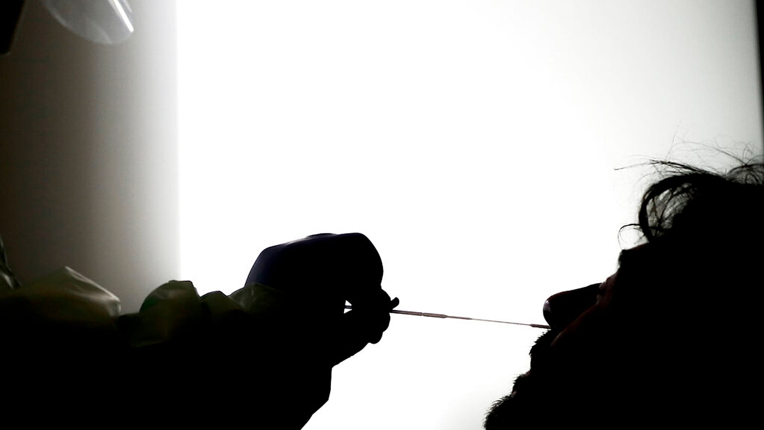 Illustrative picture: A medical staffer takes swabs as he tests for COVID-19