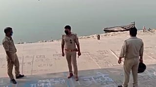 This frame grab from video provided by KK Productions shows police officials stand guard at the banks of the river where several bodies were found lying in Ghazipur district.
