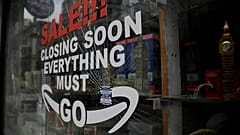In this Friday, March 26, 2021 file photo, a shattered glass window fronts a closed souvenir store in central London, during England's third coronavirus lockdown