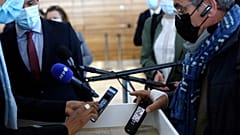 A passenger shows his mobile phone with an uploaded antigen and PCR test prior to board at the Paris-Orly airport, in Orly, south of Paris,  April 27, 2021.