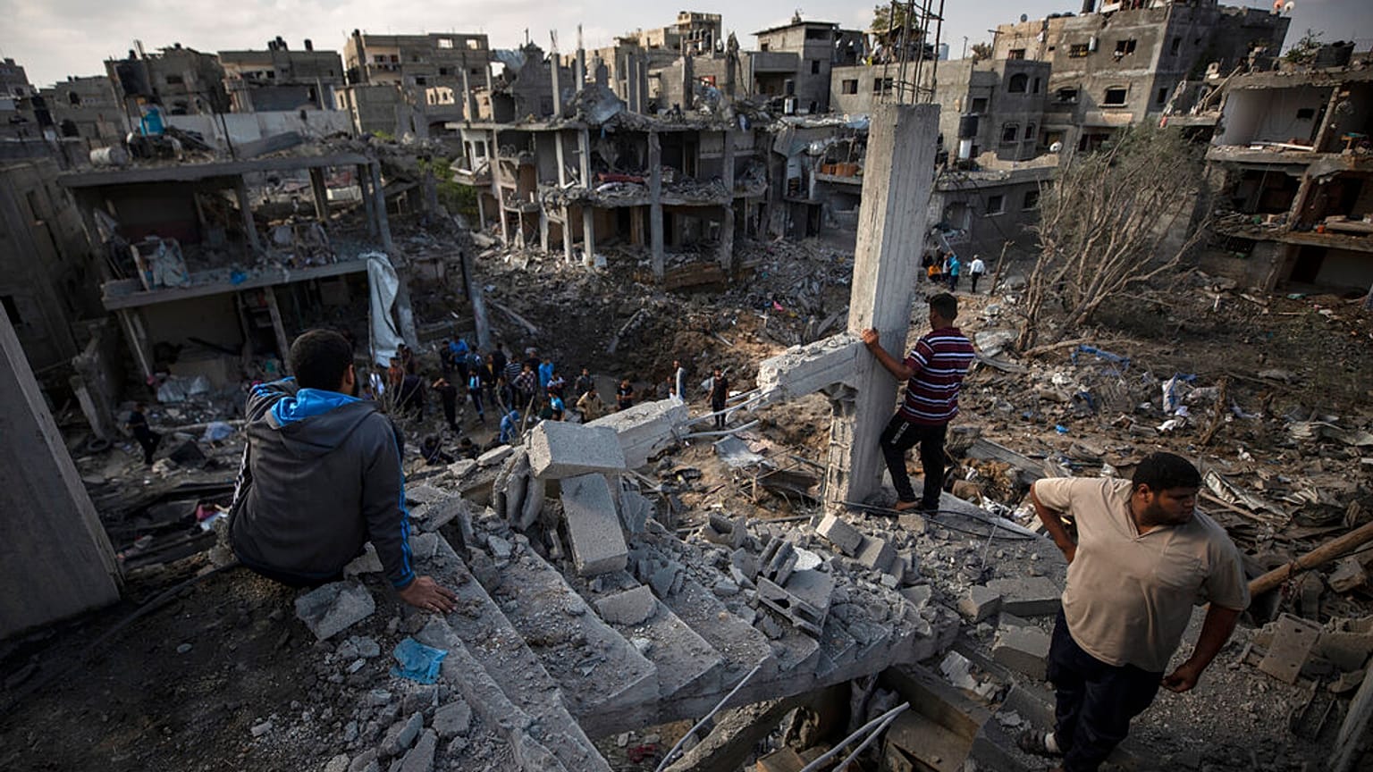 Palestinians view their destroyed houses in the town of Beit Hanoun on the northern Gaza Strip after intense bombardment on Thursday night