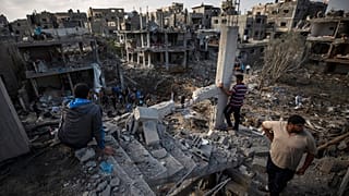 Palestinians view their destroyed houses in the town of Beit Hanoun on the northern Gaza Strip after intense bombardment on Thursday night