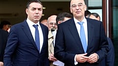 Greek Foreign Minister Nikos Dendias, right and his North Macedonia's counterpart Nikola Dimitrov