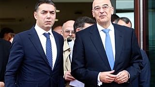 Greek Foreign Minister Nikos Dendias, right and his North Macedonia's counterpart Nikola Dimitrov