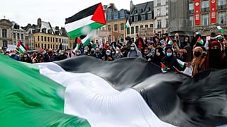 People hold Palestinian flags during a demonstration in Lille, northern France, Saturday May 15, 2021.