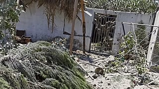 Debris from an Israeli airstrike scatters the family farm of Associated Press journalist Fares Akram on Friday, May 14, 2021, in the northern Gaza Strip.