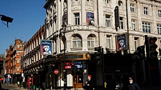 In this Friday, Feb. 26, 2021 file photo, signs for Les Miserables are displayed on the temporarily closed Gielgud Theatre during England's third coronavirus lockdown.
