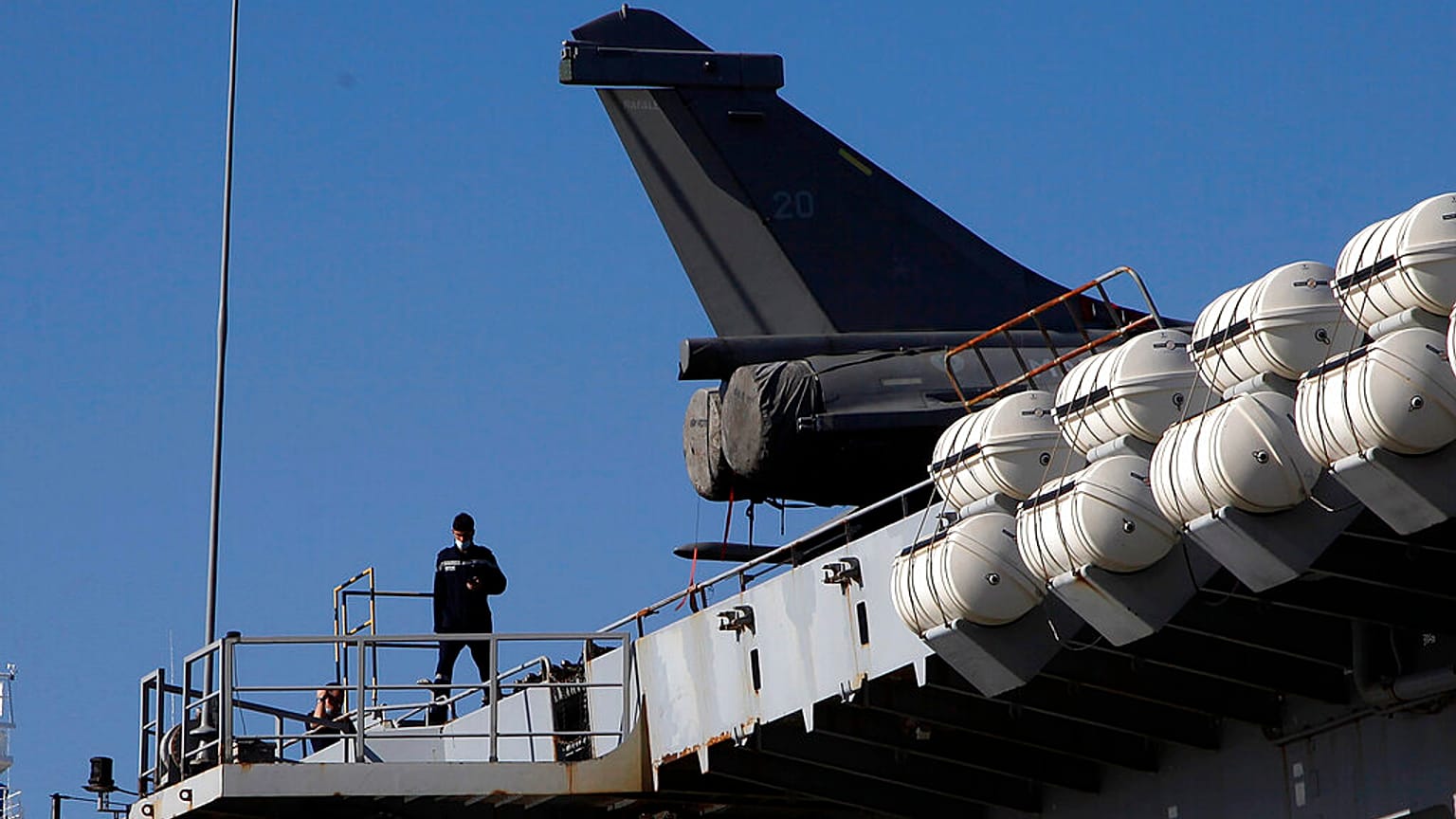 A French crew member walks on France's nuclear-powered aircraft carrier Charles de Gaulle at Limassol port, Cyprus,