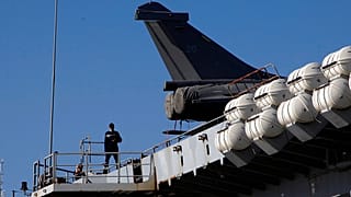 A French crew member walks on France's nuclear-powered aircraft carrier Charles de Gaulle at Limassol port, Cyprus,