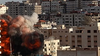 An Israeli air strike hits a building in Gaza City, Monday, May 17, 2021. 