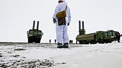 An officer stands as the Bastion anti-ship missile systems take positions on the Alexandra Land island near Nagurskoye, Russia, Monday, May 17, 2021.