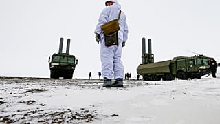 An officer stands as the Bastion anti-ship missile systems take positions on the Alexandra Land island near Nagurskoye, Russia, Monday, May 17, 2021.