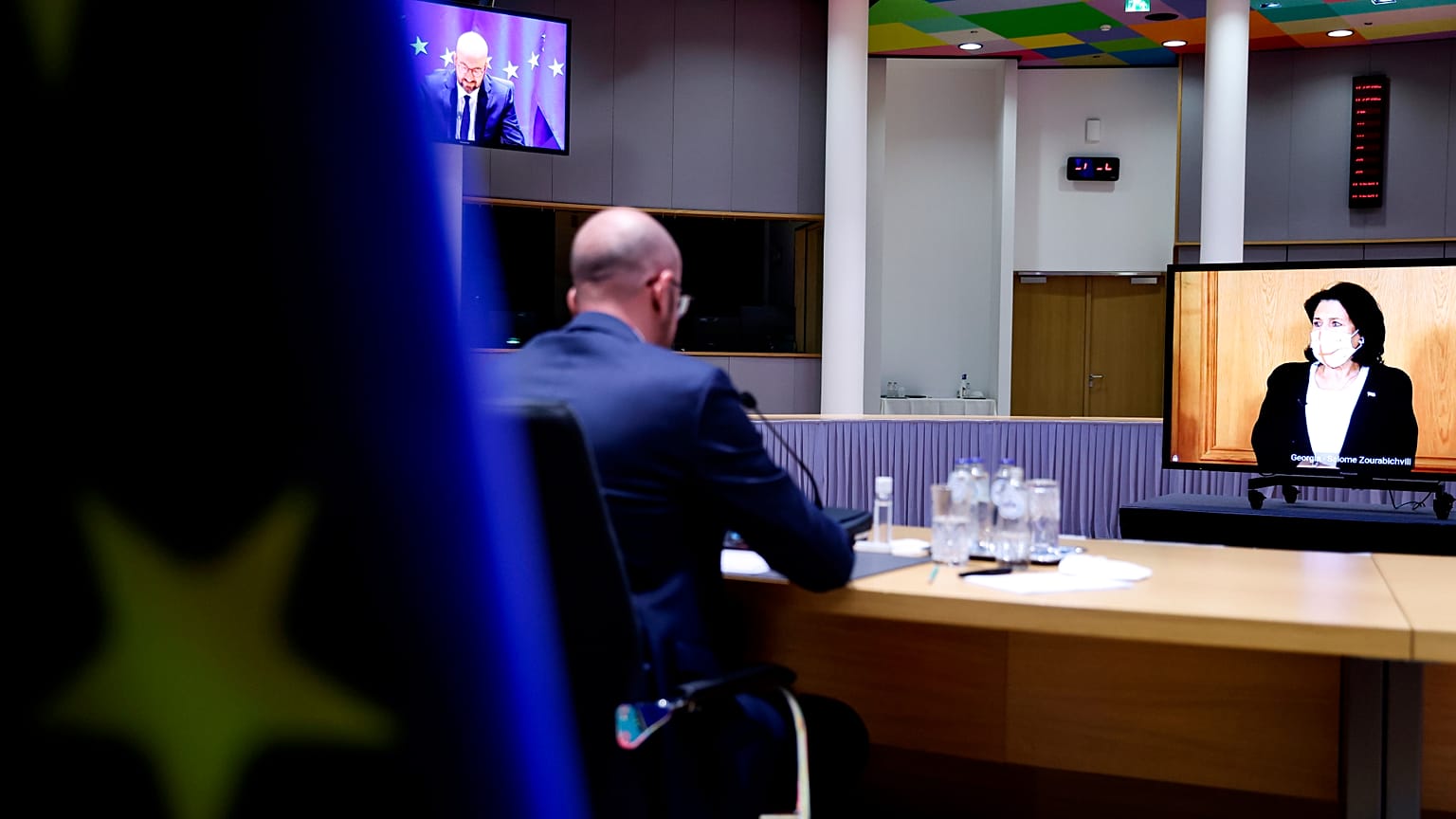 European Council President Charles Michel, left, speaks with Georgian President Salome Zurabishvili, on screen, during a video conference at the European Council on April 19