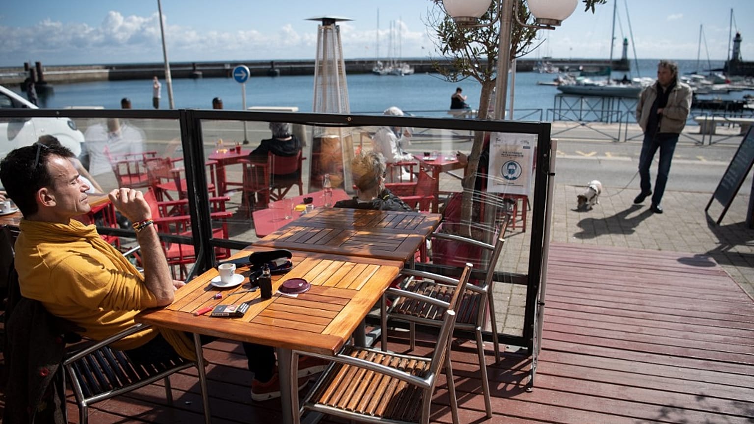 A person sit at a cafe terrace in Le Palais, France
