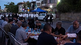 Palestinian Muslims break their fast while Israeli settlers gather in the neighbourhood of Sheikh Jarrah