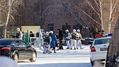 Armed police officers block an area around a school in Sosnovy Bor on the outskirts of Ulan-Ude, the regional capital of Buryatia.