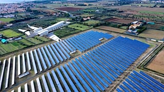 Airplane flying over a solar farm