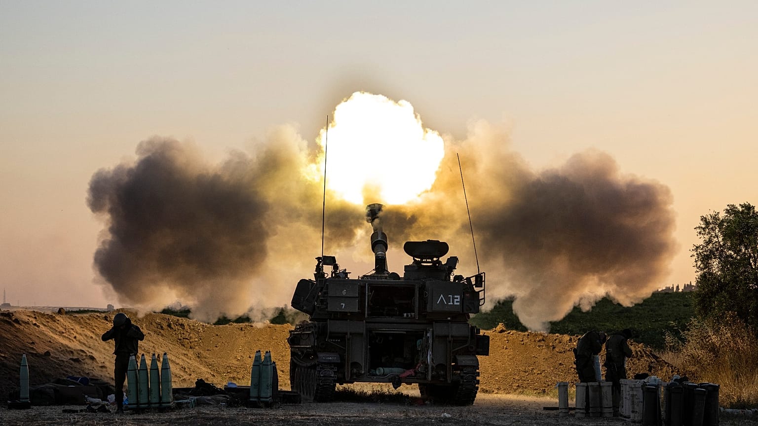 An Israeli artillery unit fires shells towards targets in Gaza Strip, at the Israeli Gaza border, Wednesday, May 19, 2021.