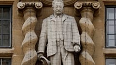 A statue of Cecil Rhodes, a controversial Victorian imperialist, stands mounted on the facade of Oriel College in Oxford, England, June 17, 2020.