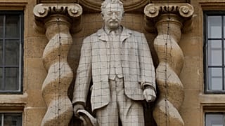 A statue of Cecil Rhodes, a controversial Victorian imperialist, stands mounted on the facade of Oriel College in Oxford, England, June 17, 2020.