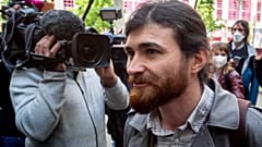 The suspect, Franco A., arrives at a Frankfurt court for the start of his trial.