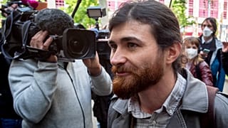 The suspect, Franco A., arrives at a Frankfurt court for the start of his trial.