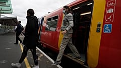Passengers step off a train in London, Thursday, May 20, 2021.