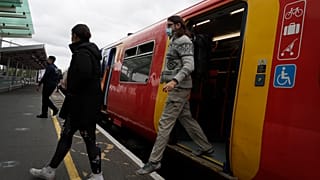 Passengers step off a train in London, Thursday, May 20, 2021.