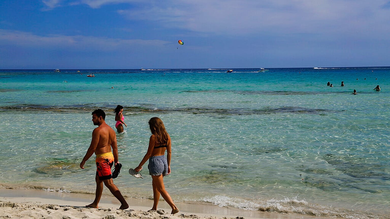 A couple walk on the beach in the southeast resort of Ayia Napa, Cyprus on May 16, 2021.