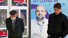 Moscow: poster showing a portrait of Dr. Denis Protsenko and words reading "Get vaccinated against covid-19!!"